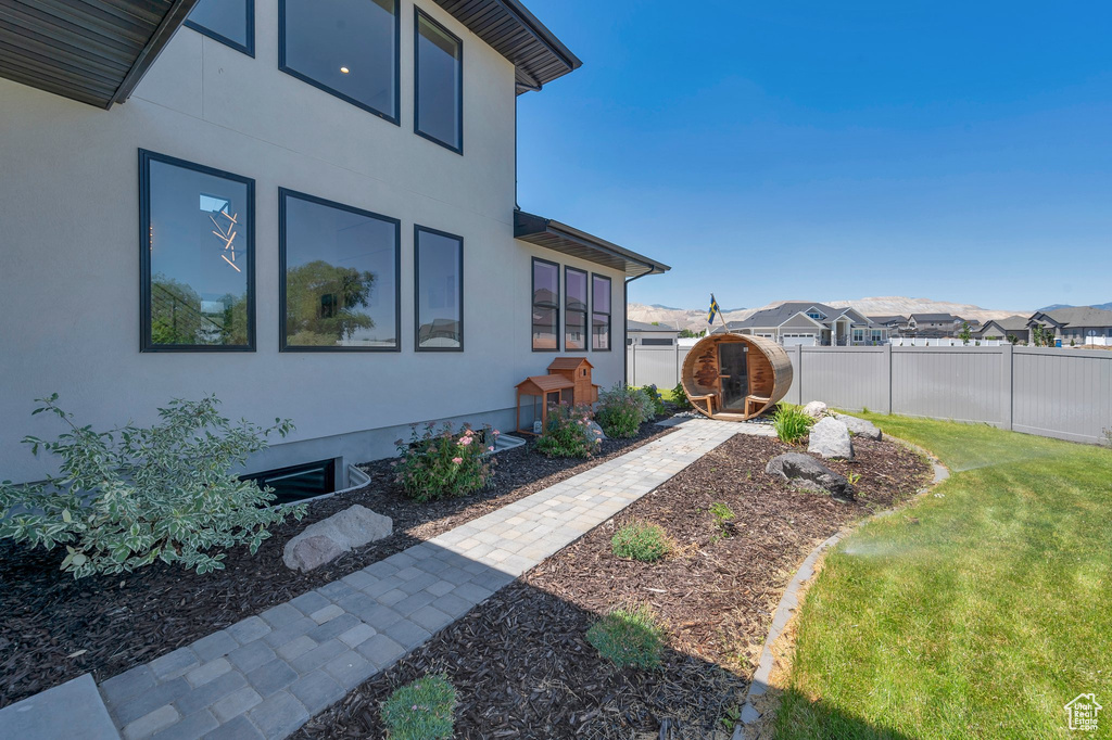 View of side of property with a lawn