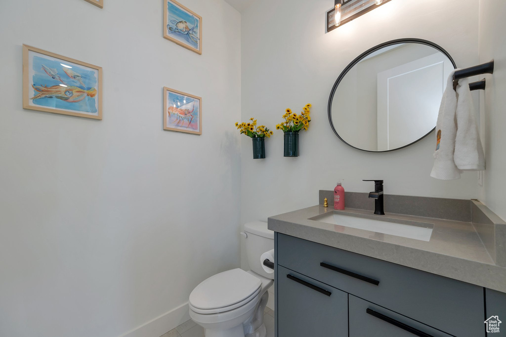 Bathroom with vanity, toilet, and tile patterned flooring