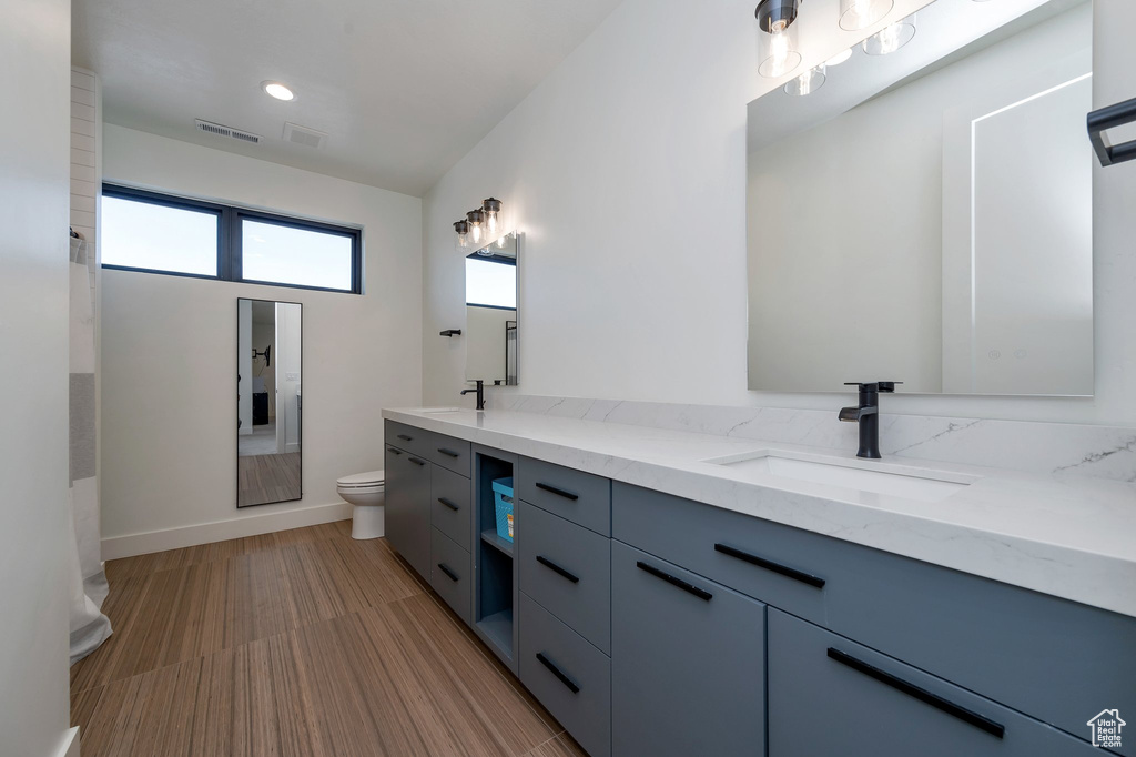 Bathroom featuring vanity and toilet