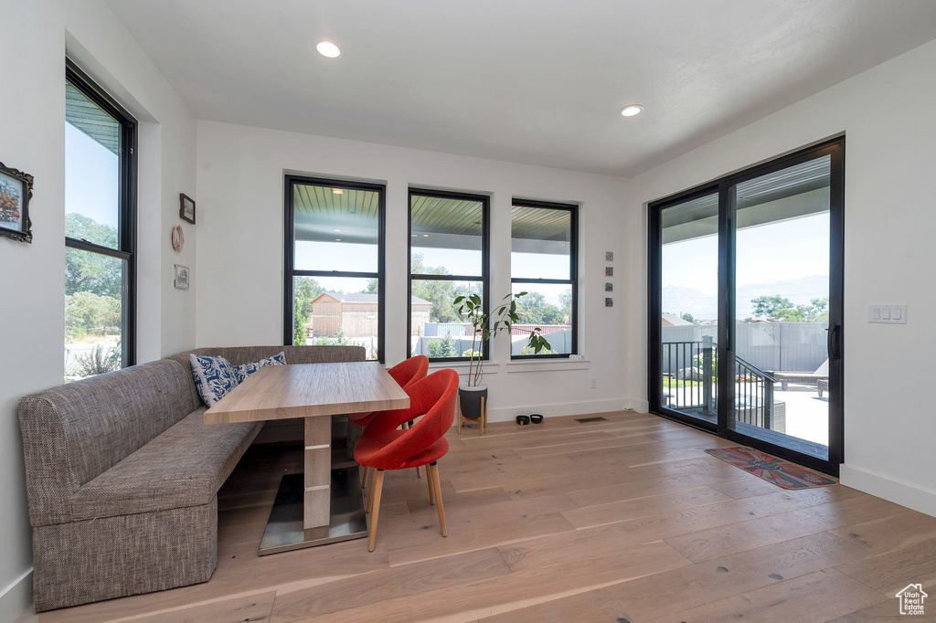 Dining space with hardwood / wood-style flooring and plenty of natural light