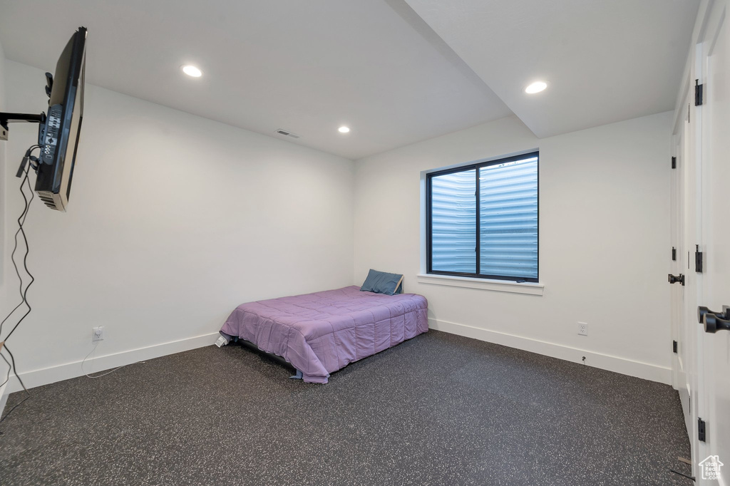 Bedroom with dark colored carpet