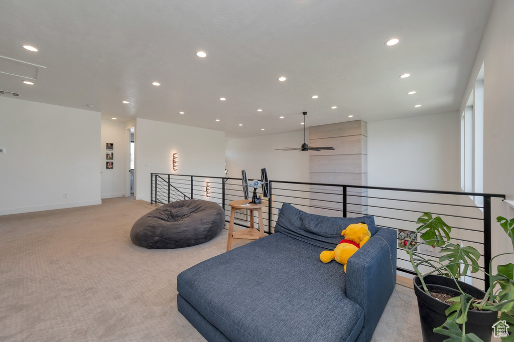 Sitting room with carpet and ceiling fan