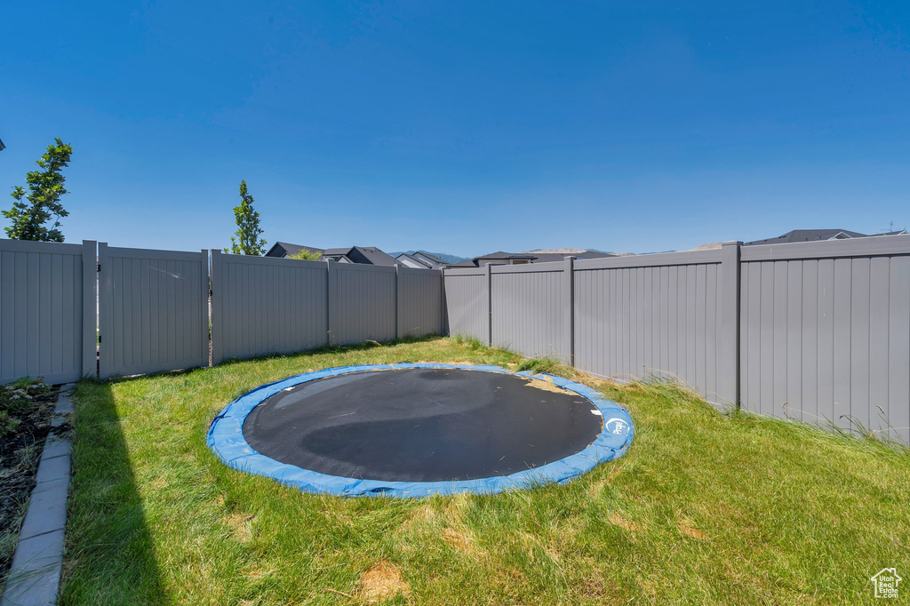 View of yard featuring a trampoline