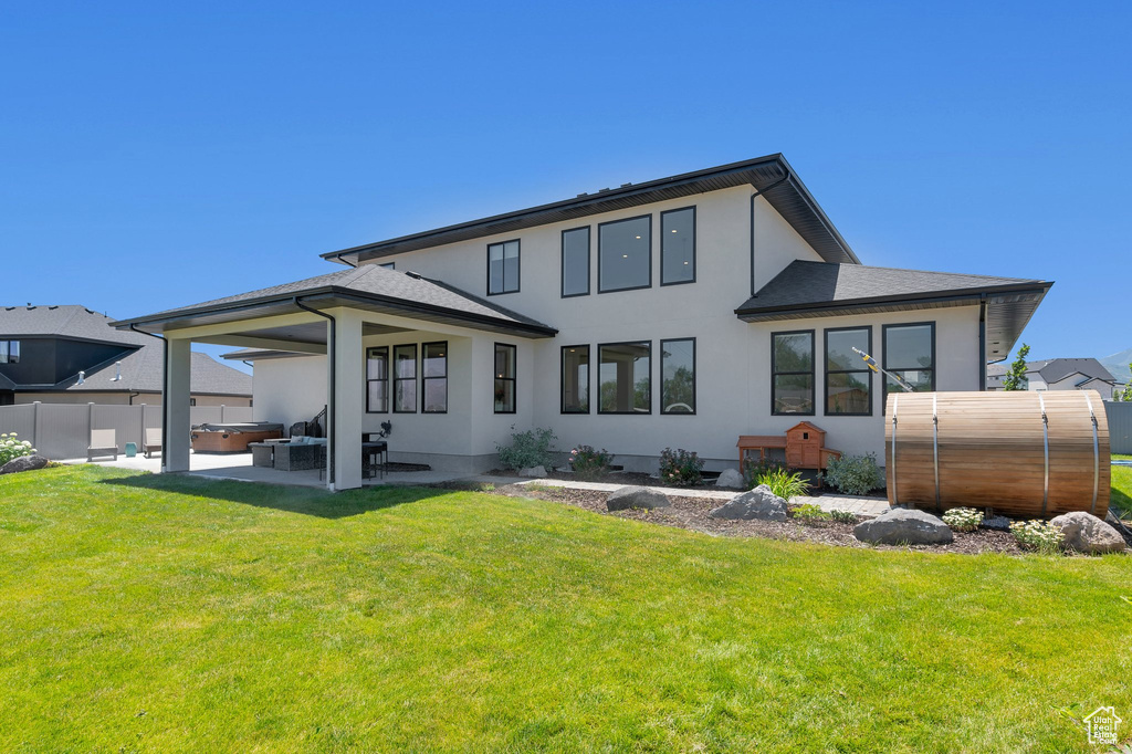 Back of house with an outdoor living space, a yard, and a patio area