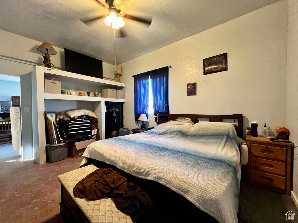 Bedroom with a textured ceiling and ceiling fan