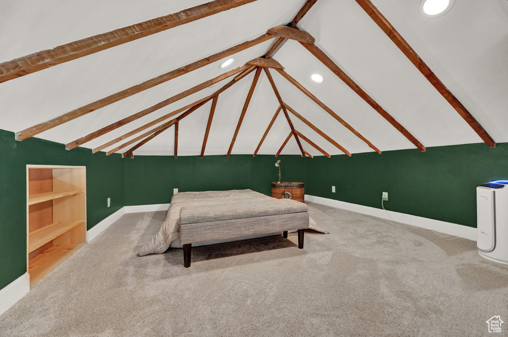 Bedroom featuring lofted ceiling with beams and carpet flooring