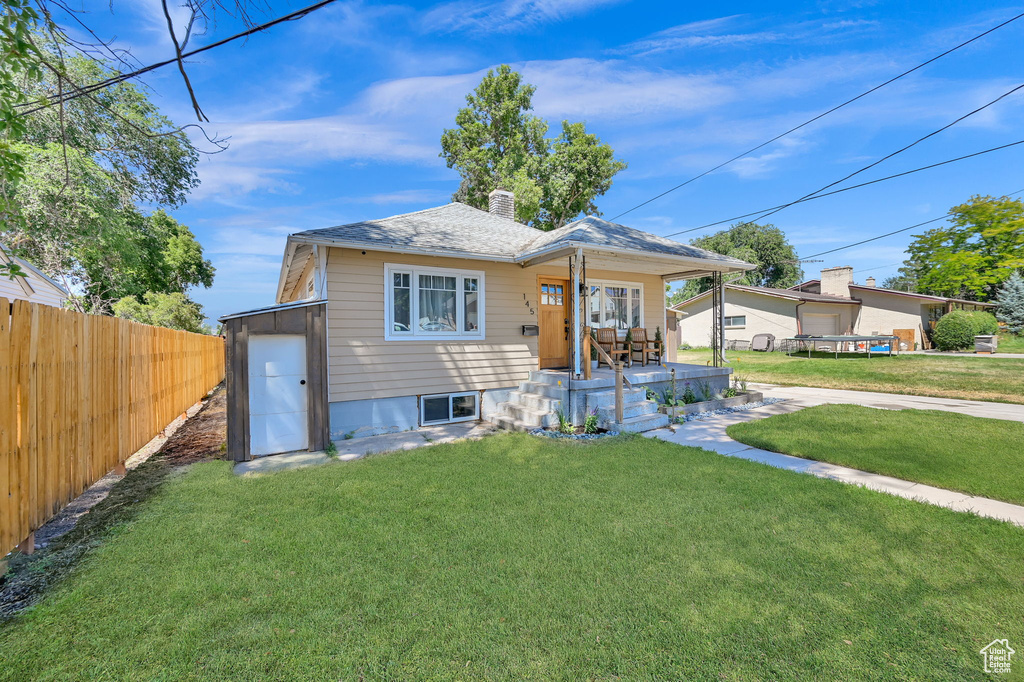 Bungalow-style home with a front yard