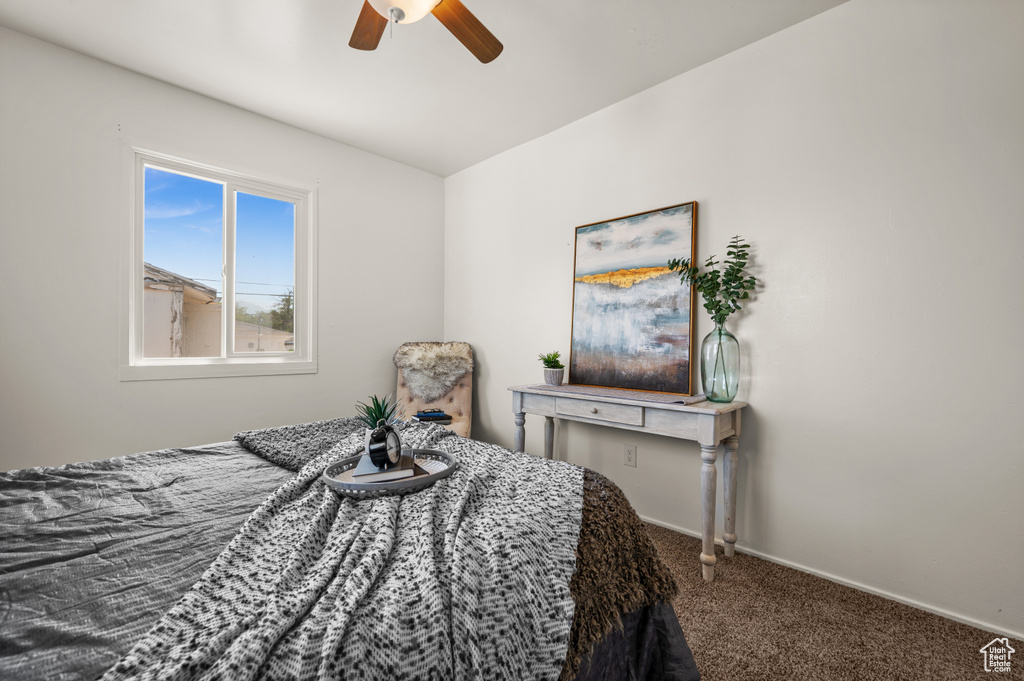 Carpeted bedroom with ceiling fan