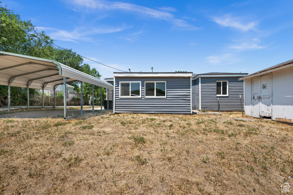 Back of property with a carport