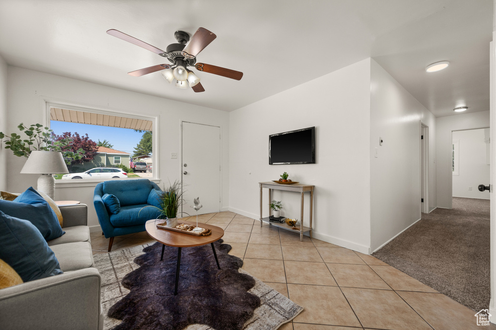 Living room with light colored carpet and ceiling fan