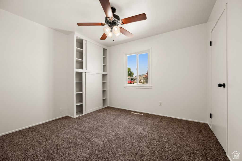 Unfurnished bedroom featuring carpet and ceiling fan