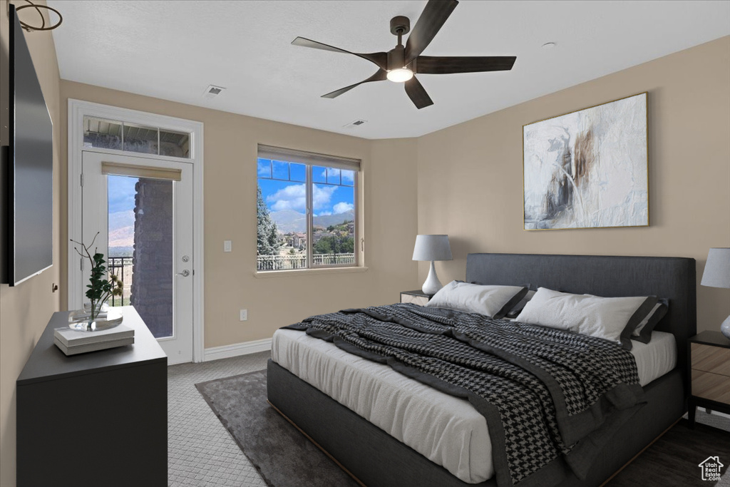 Carpeted bedroom featuring access to outside and ceiling fan