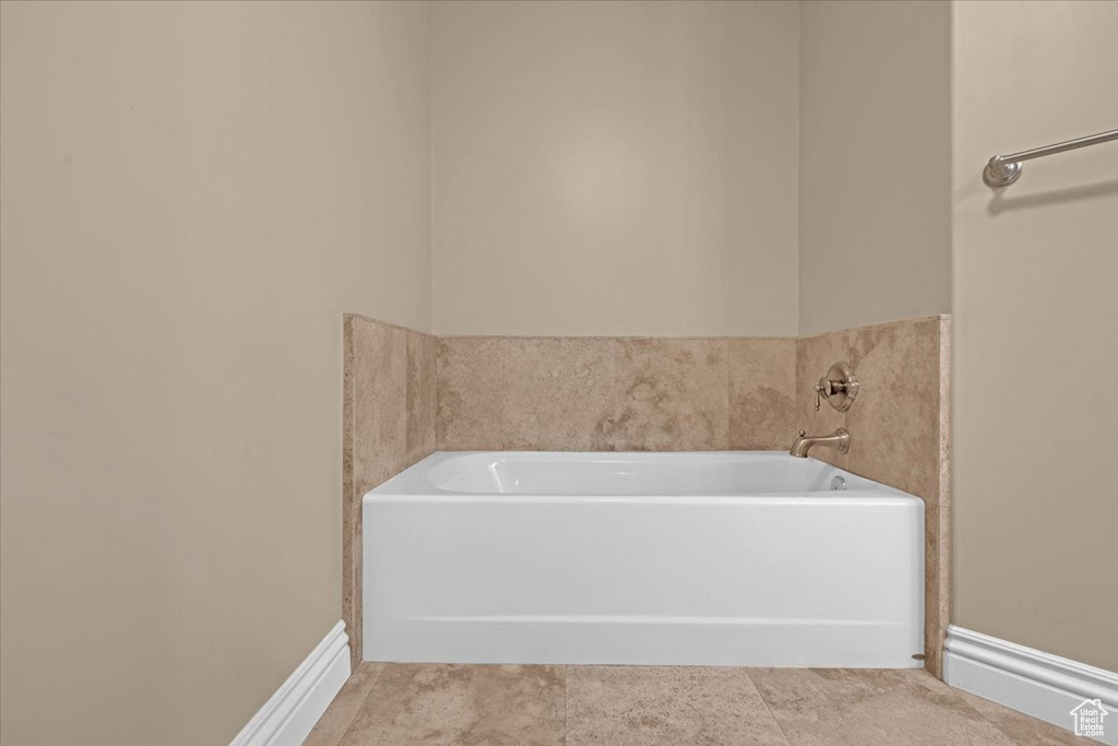 Bathroom with tile patterned floors and a bathtub