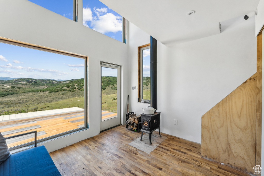 Interior space with hardwood / wood-style flooring and a wood stove