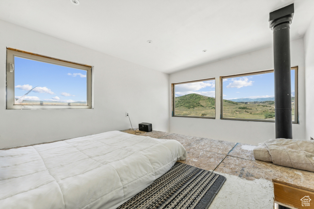 Tiled bedroom with multiple windows