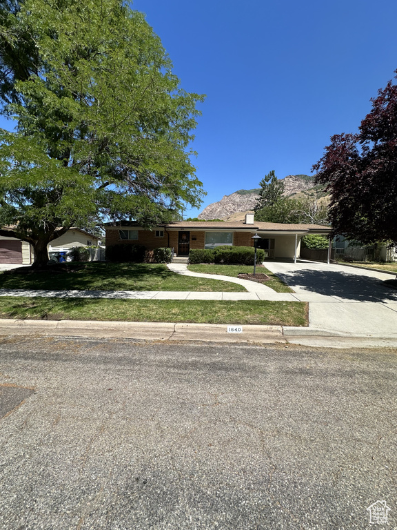 Ranch-style house featuring a mountain view and a carport