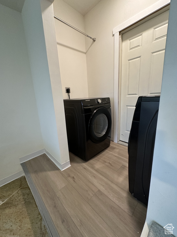 Laundry area featuring washer / clothes dryer and hardwood / wood-style flooring