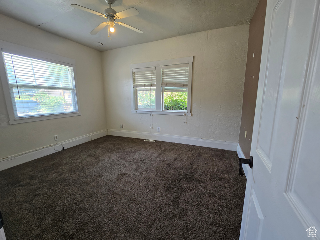 Spare room with carpet and ceiling fan