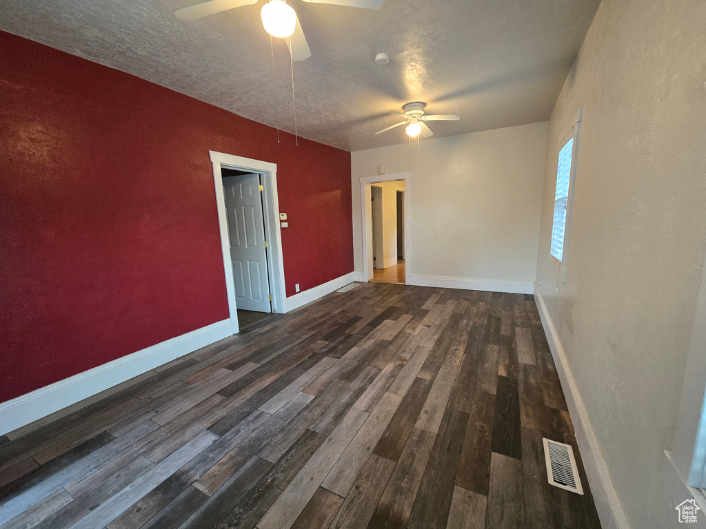 Spare room featuring hardwood / wood-style flooring, a textured ceiling, and ceiling fan