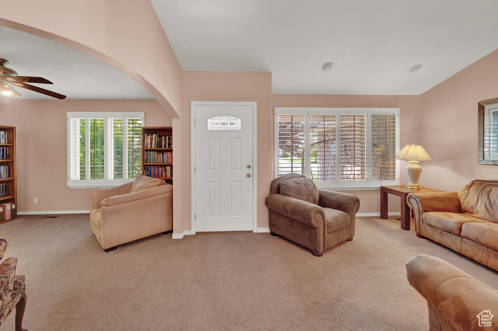 Living room with carpet flooring and ceiling fan