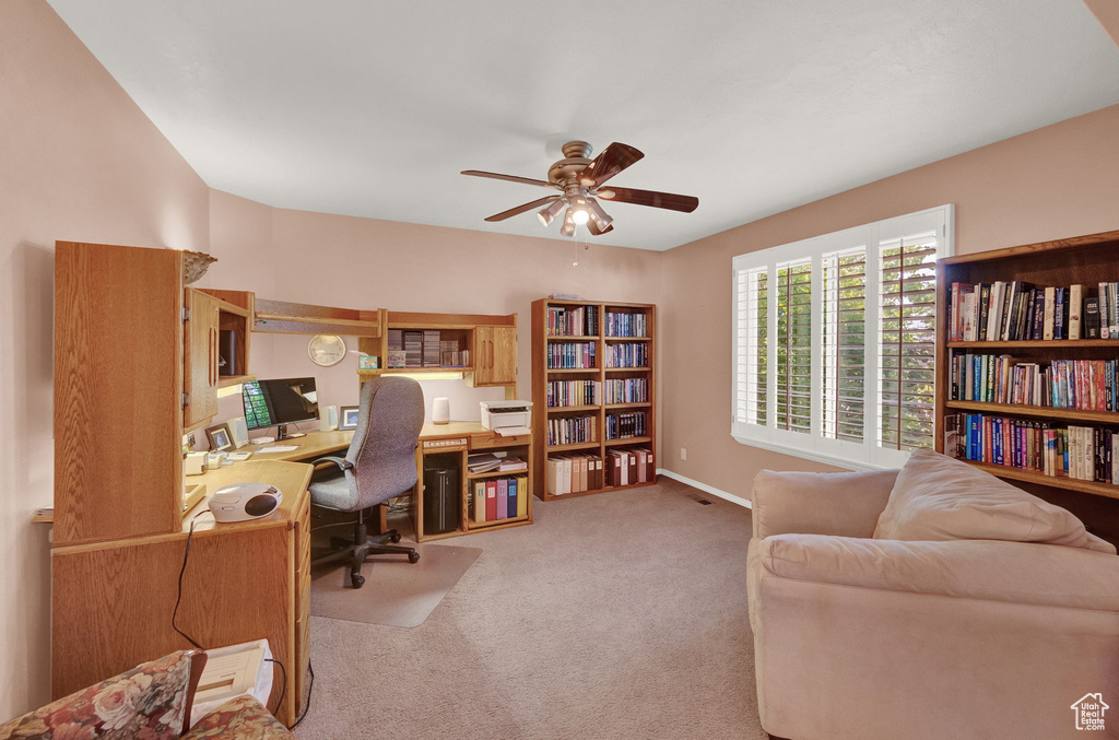 Office area with carpet flooring and ceiling fan