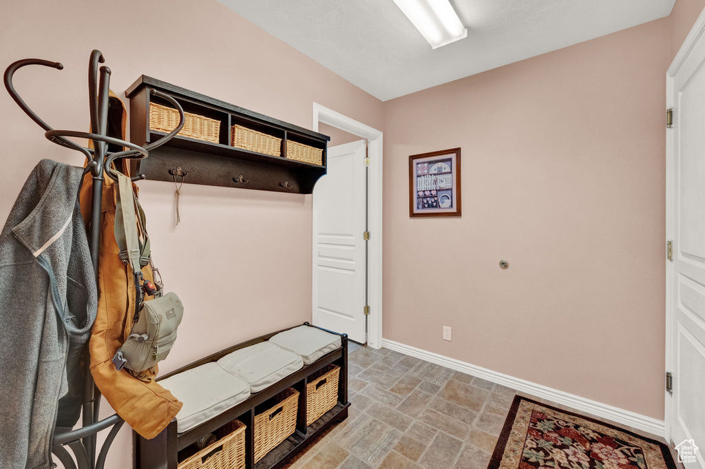 Mudroom with tile patterned floors