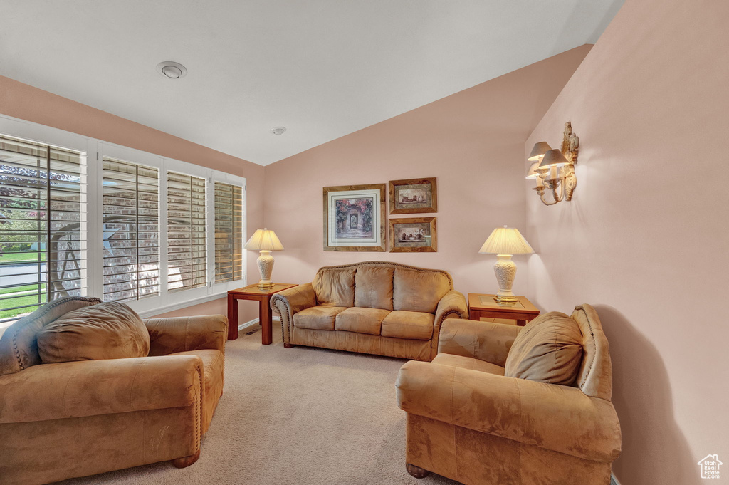 Carpeted living room with vaulted ceiling