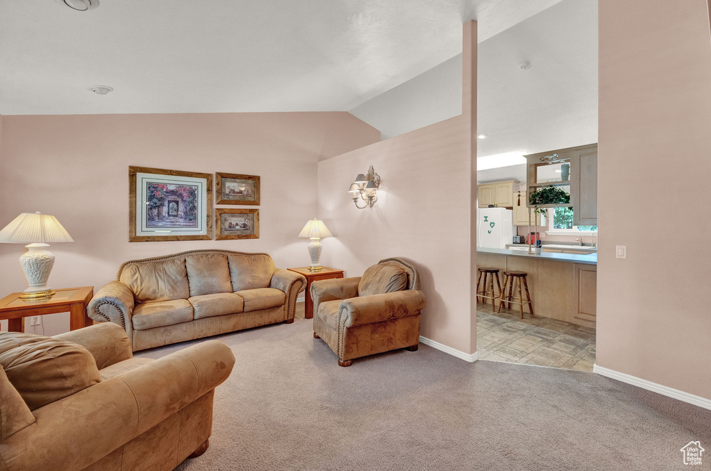 Living room featuring lofted ceiling and light colored carpet