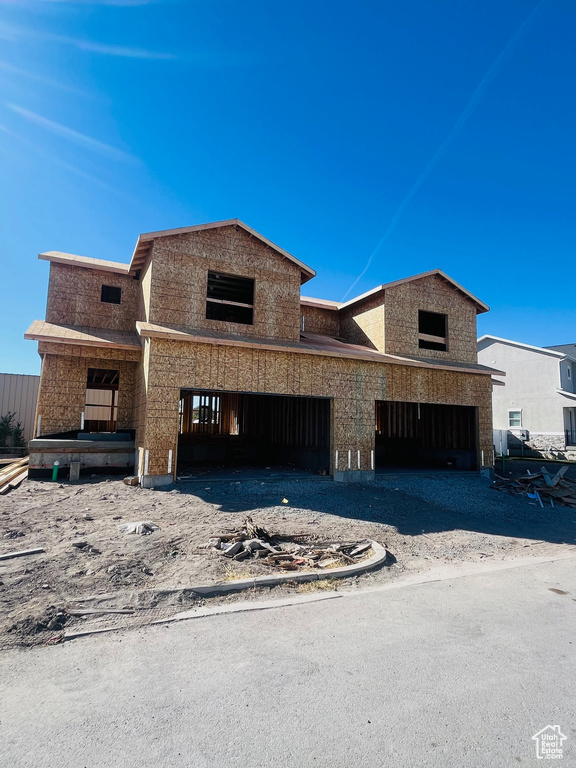 Unfinished property featuring a garage