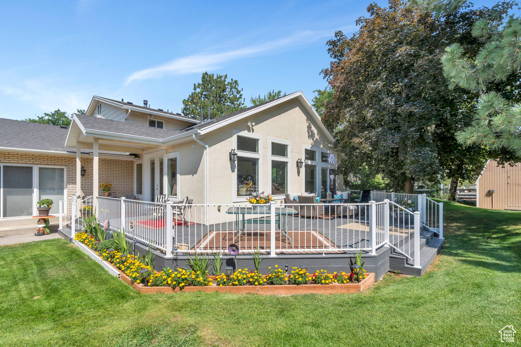 Rear view of house featuring a lawn