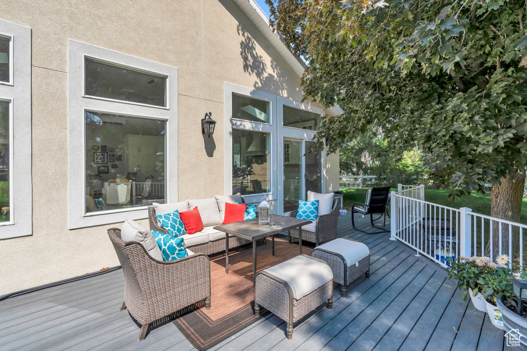 Wooden deck featuring an outdoor living space