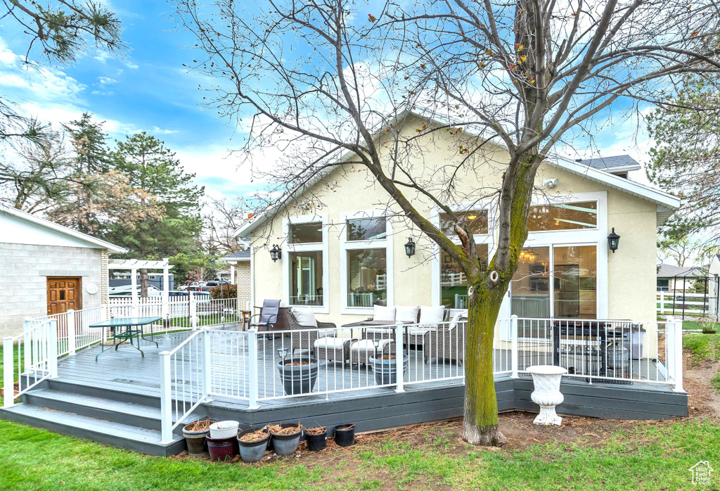 Back of property featuring a wooden deck