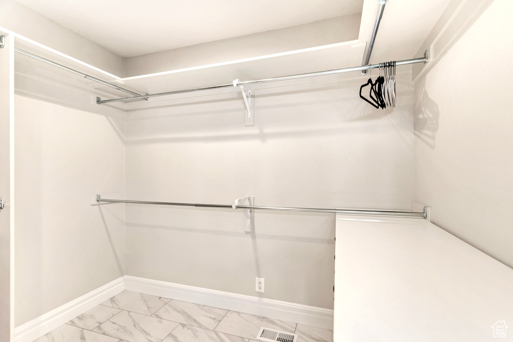 Walk in closet featuring light tile patterned floors