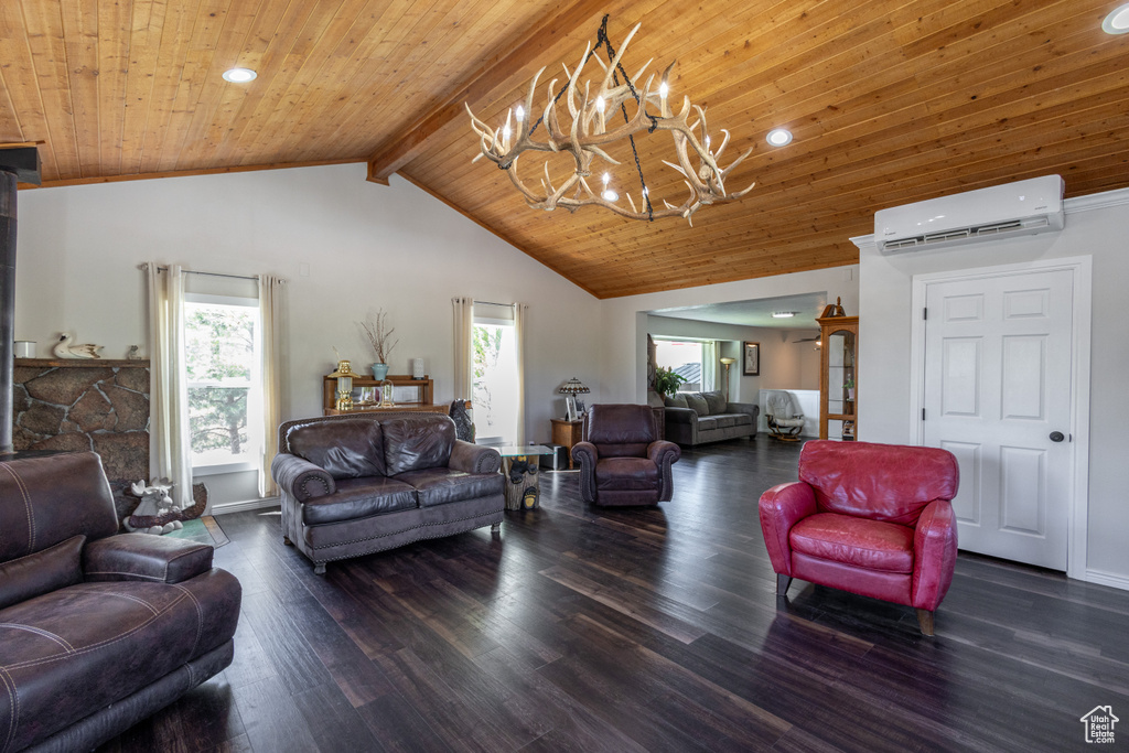 Living room featuring beamed ceiling, an inviting chandelier, a wall mounted air conditioner, high vaulted ceiling, and dark wood-type flooring