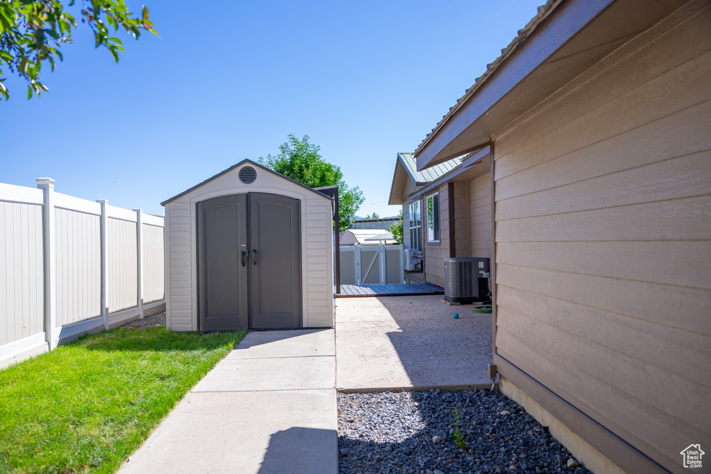 Exterior space featuring central air condition unit and a storage shed