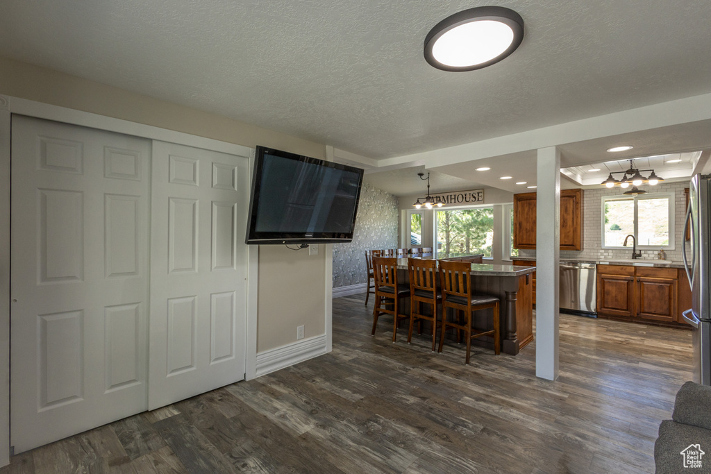 Kitchen featuring dark hardwood / wood-style floors, plenty of natural light, and a chandelier