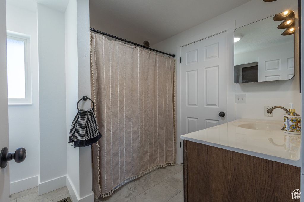 Bathroom featuring vanity and tile patterned floors