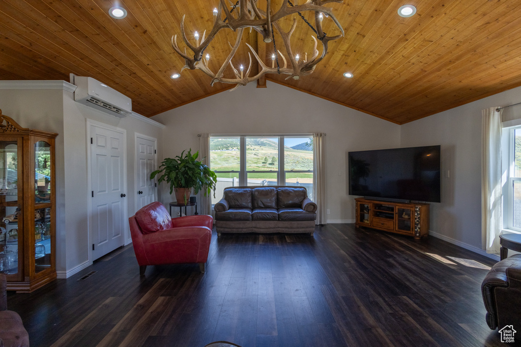 Living room featuring a wall mounted AC, lofted ceiling, a chandelier, wood-type flooring, and ornamental molding