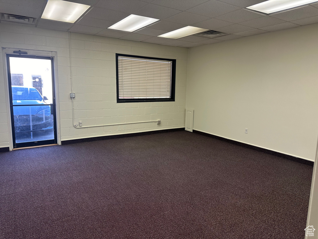 Unfurnished room featuring dark colored carpet