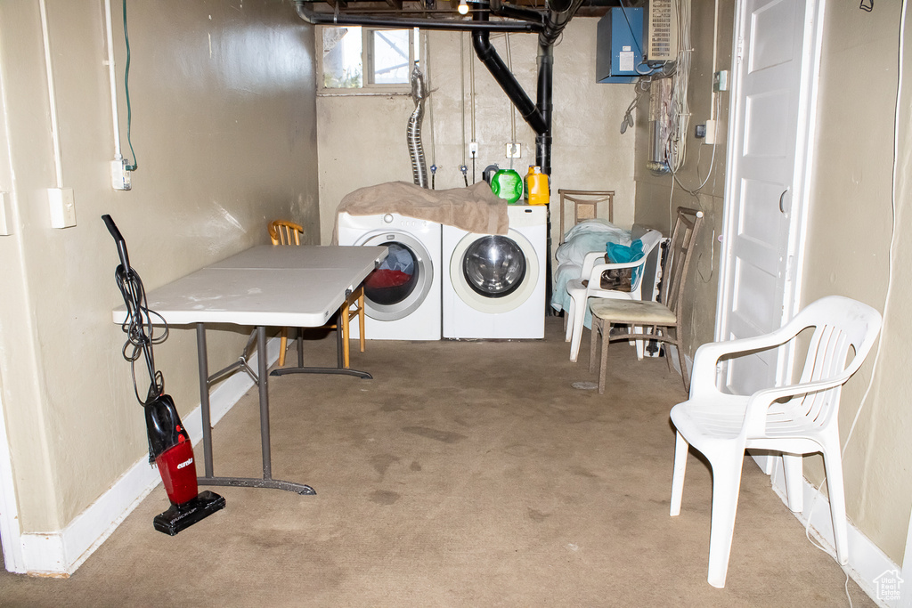 Interior space featuring water heater, separate washer and dryer, and carpet flooring