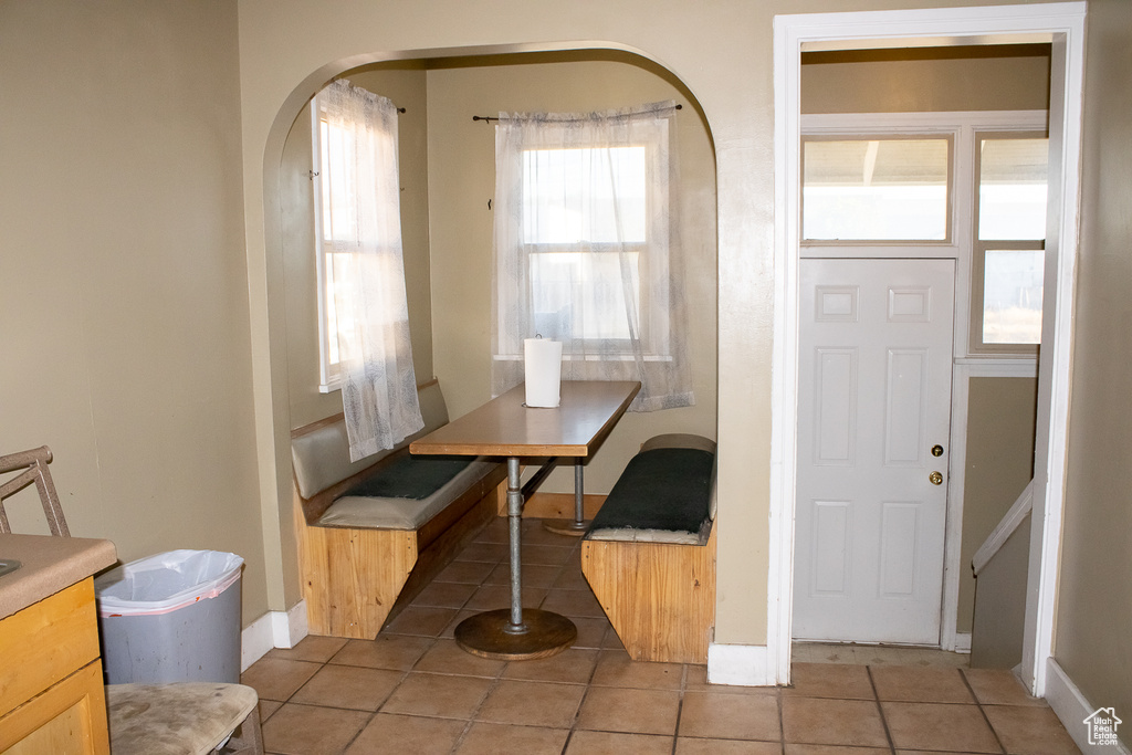 Dining space with tile patterned flooring