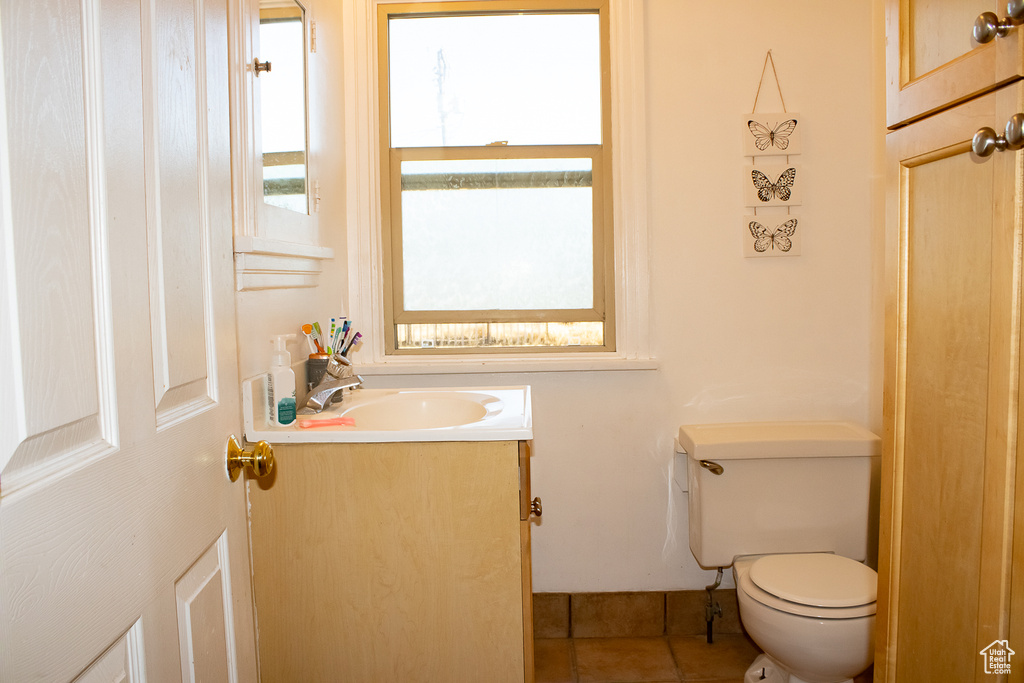 Bathroom with vanity, tile patterned floors, and toilet