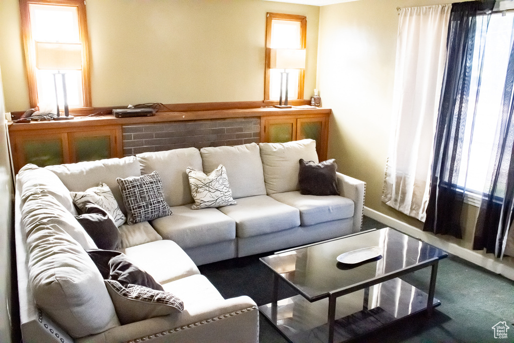 Living room featuring a wealth of natural light and dark carpet