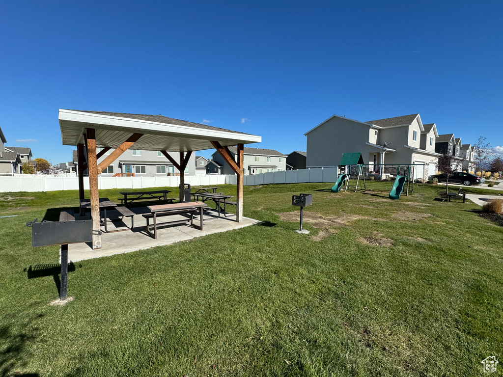 View of property\\\\\\\'s community featuring a gazebo, a playground, and a lawn