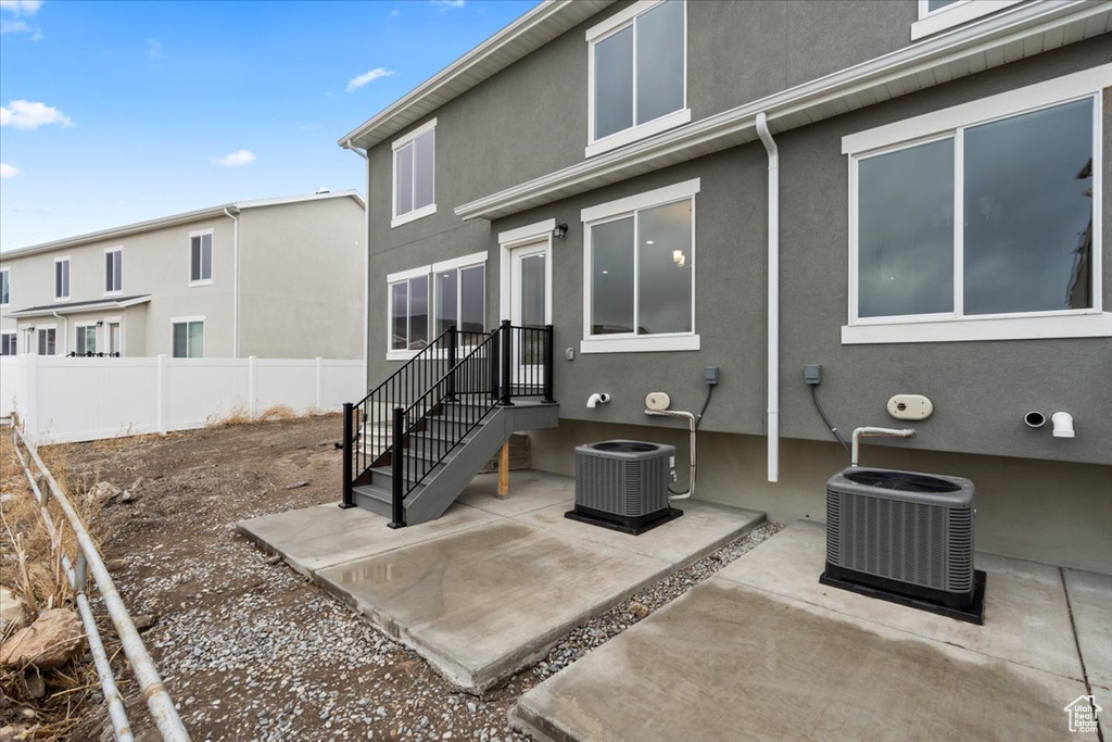 Rear view of house with a patio and cooling unit