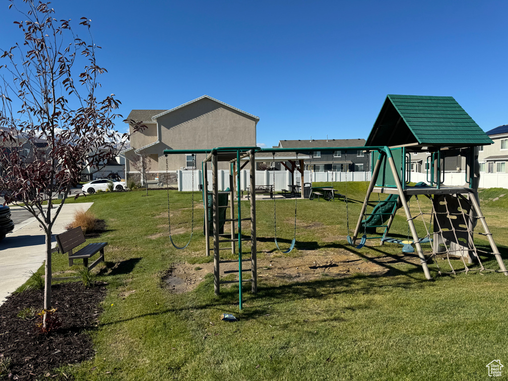View of jungle gym with a lawn