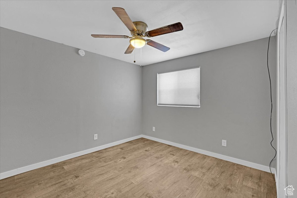 Empty room with light wood-type flooring and ceiling fan