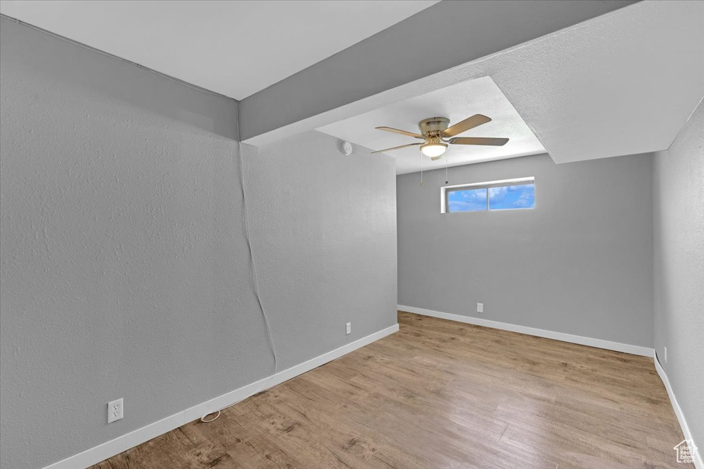 Unfurnished room with light wood-type flooring and ceiling fan