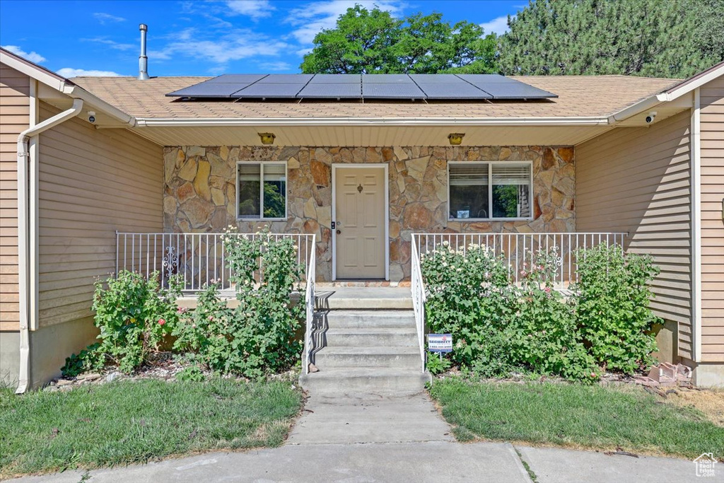 View of front of property with solar panels