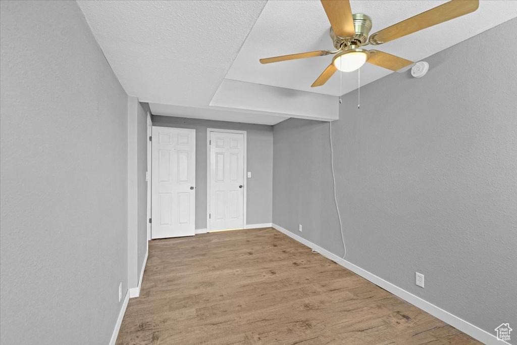 Unfurnished room featuring ceiling fan and hardwood / wood-style floors